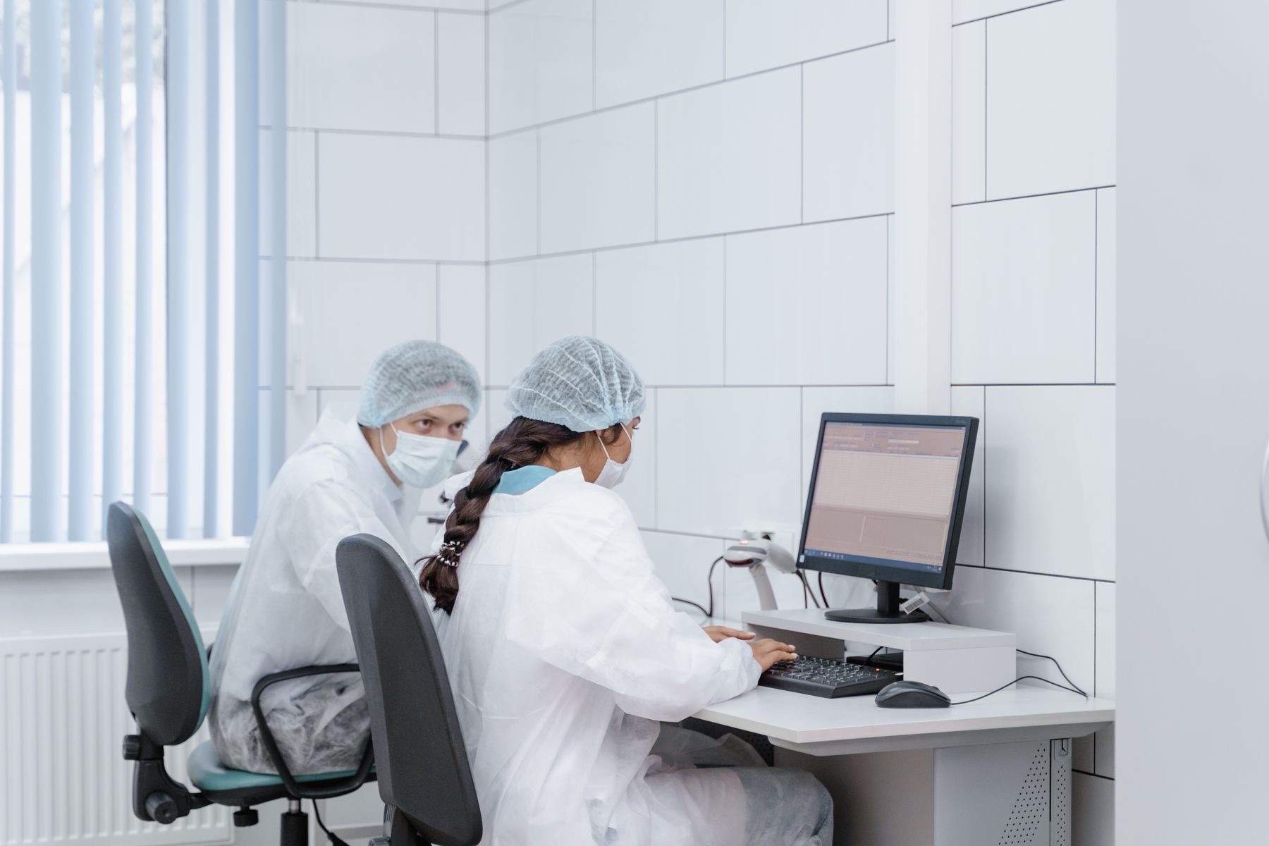 Researchers reviewing laboratory data on a computer